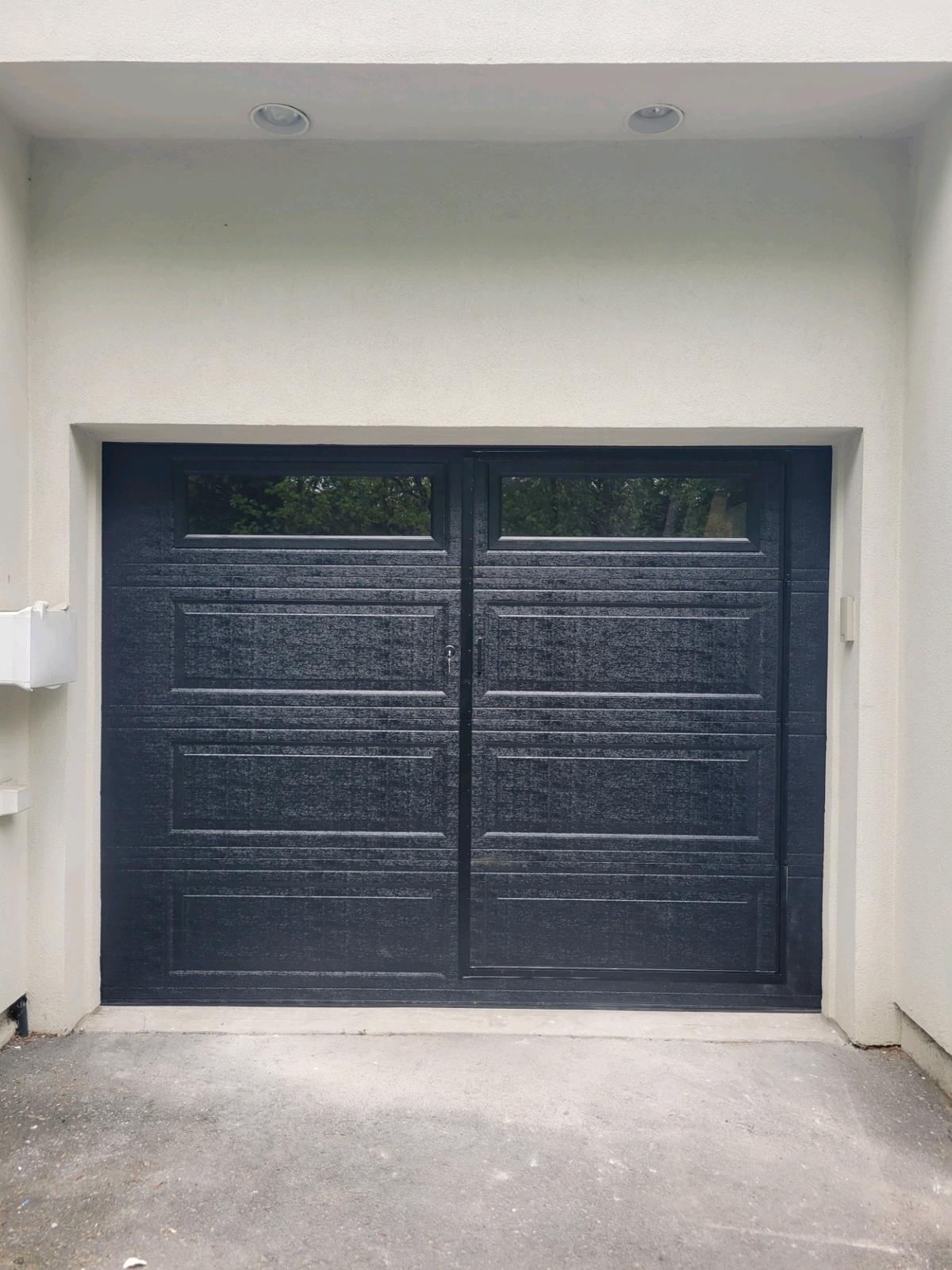 Modern matte-black swing garage door installation